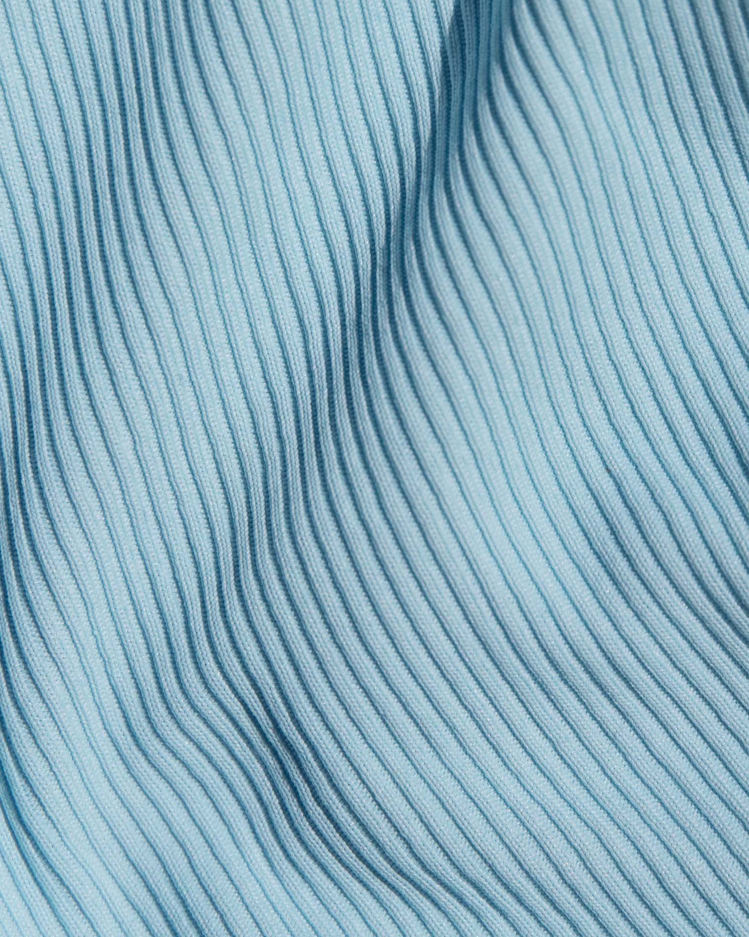A close-up of a light blue ribbed knit fabric.