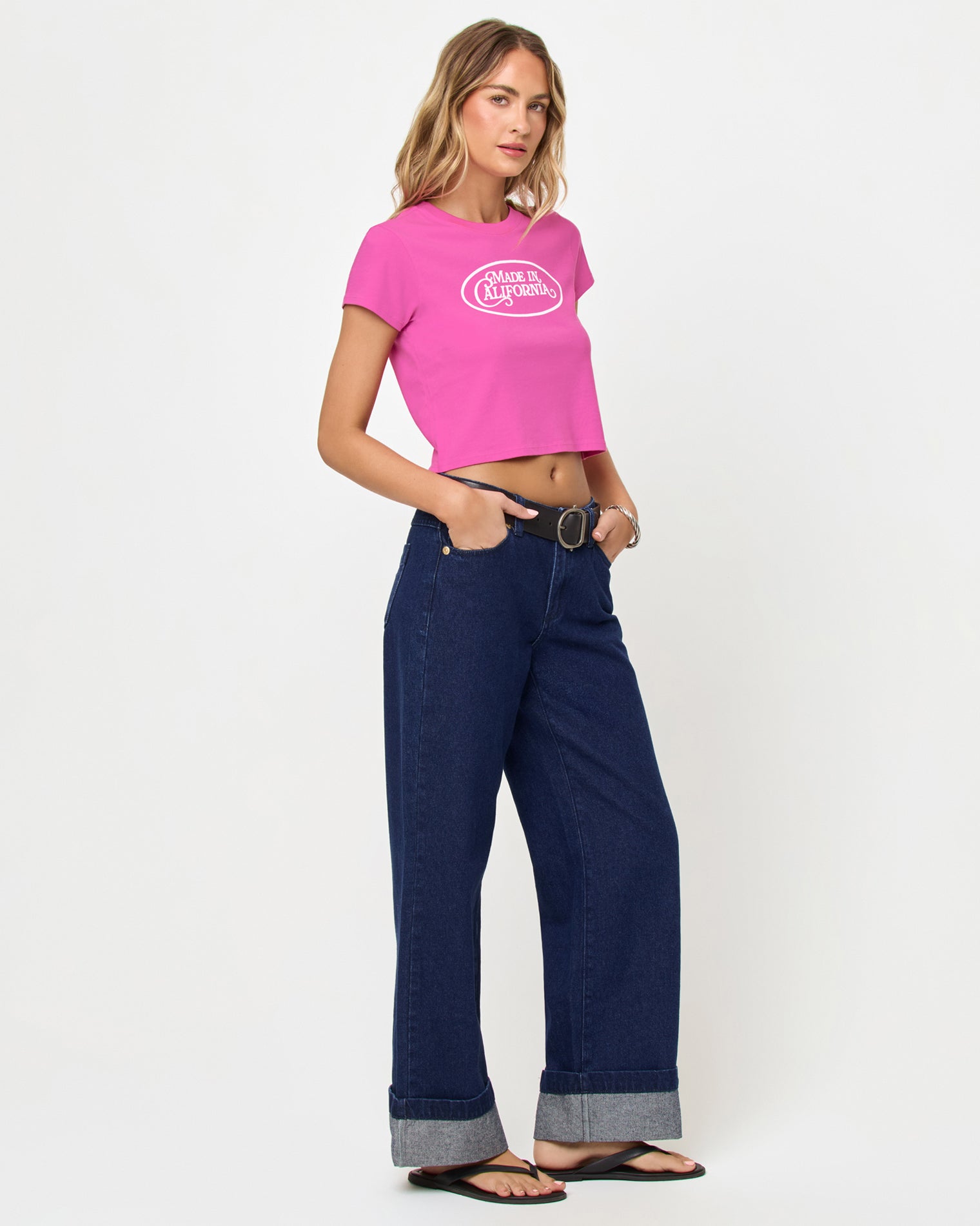 Side view of model wearing the Merci Baby Tee in Sweetheart Made in California.