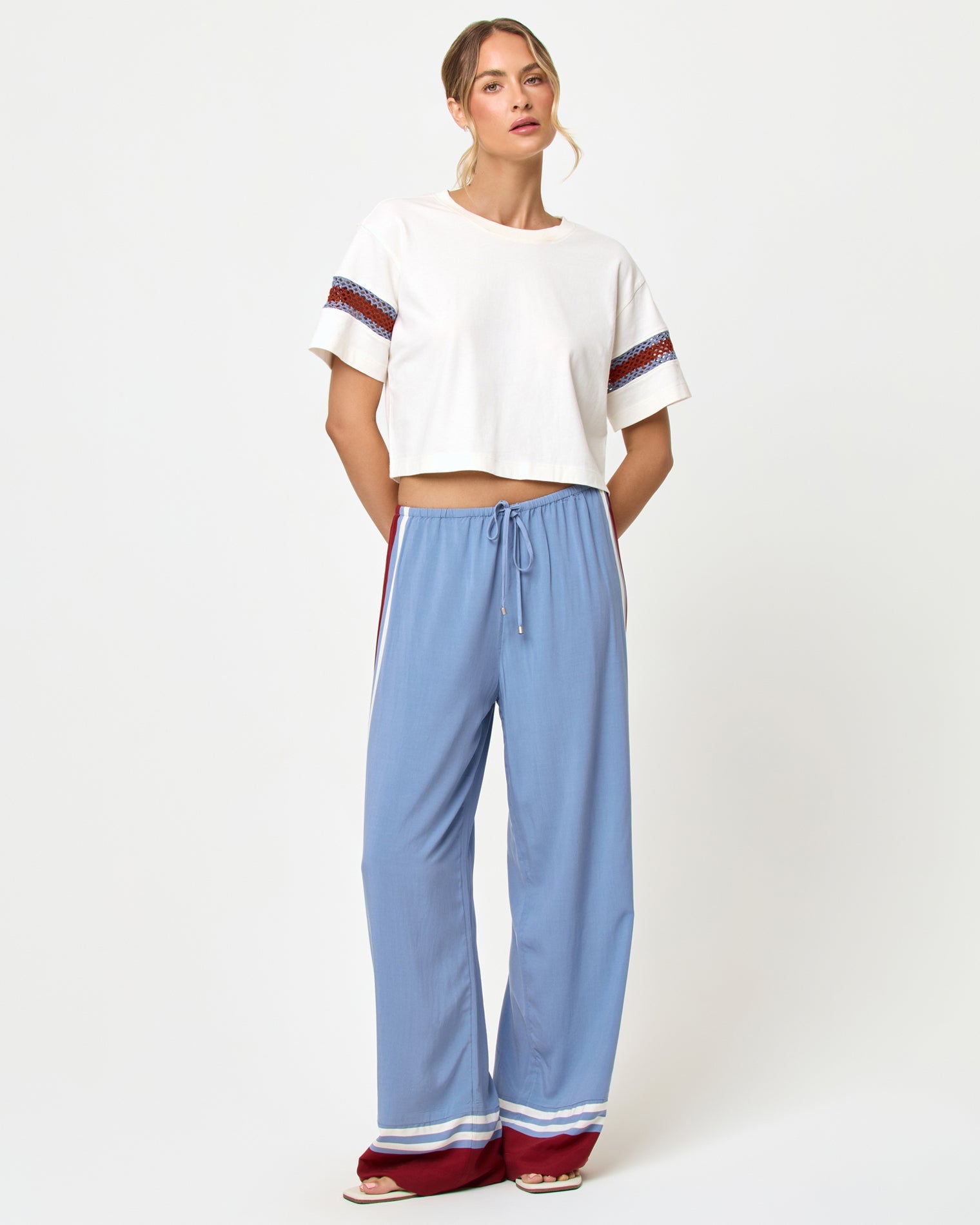 Front view of model wearing the LSPACE Unwind Pant in unwind stripe, a relaxed wide-leg striped pant with drawstring waist.