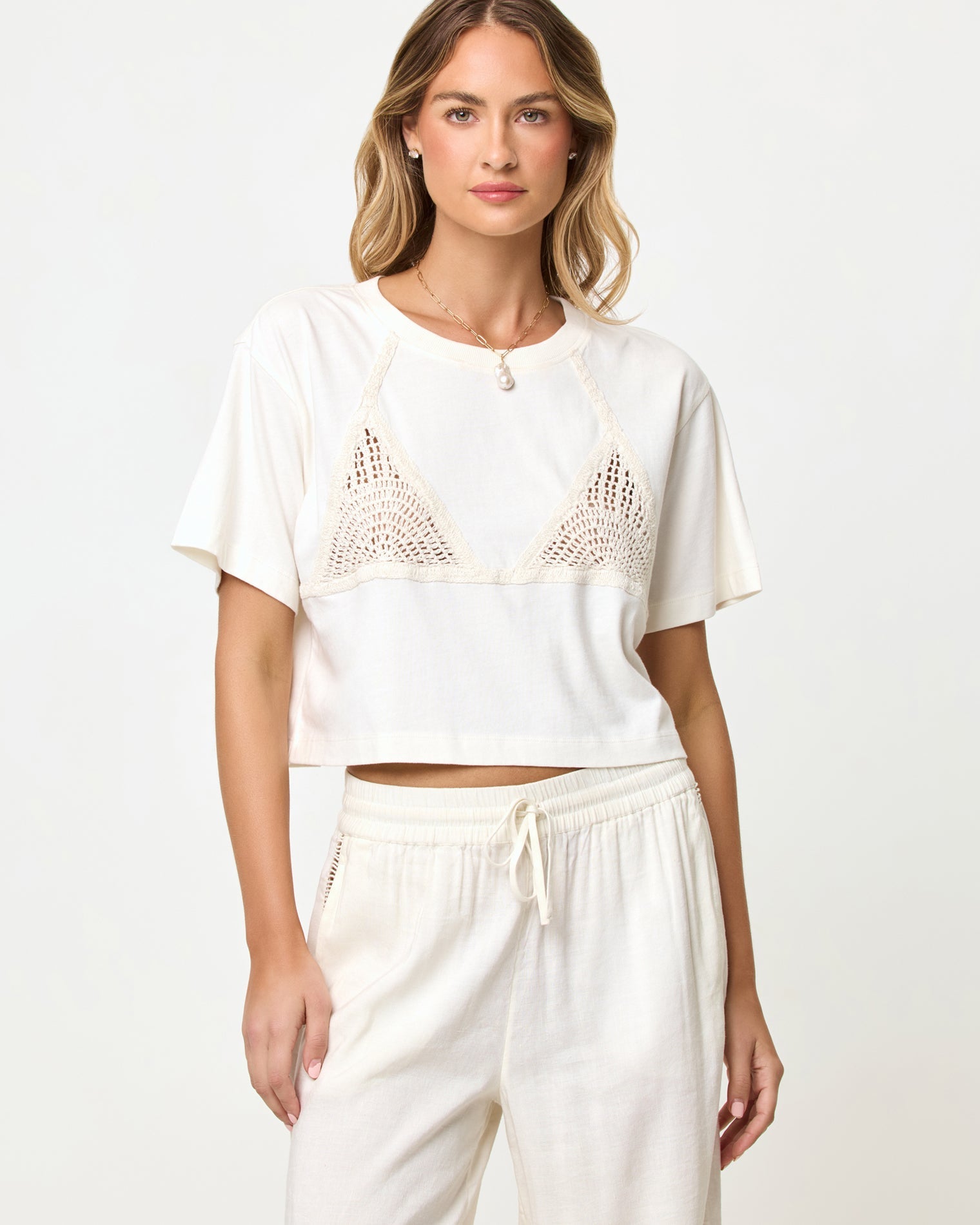 Back view of model wearing the LSPACE Core Top in cream-natural.