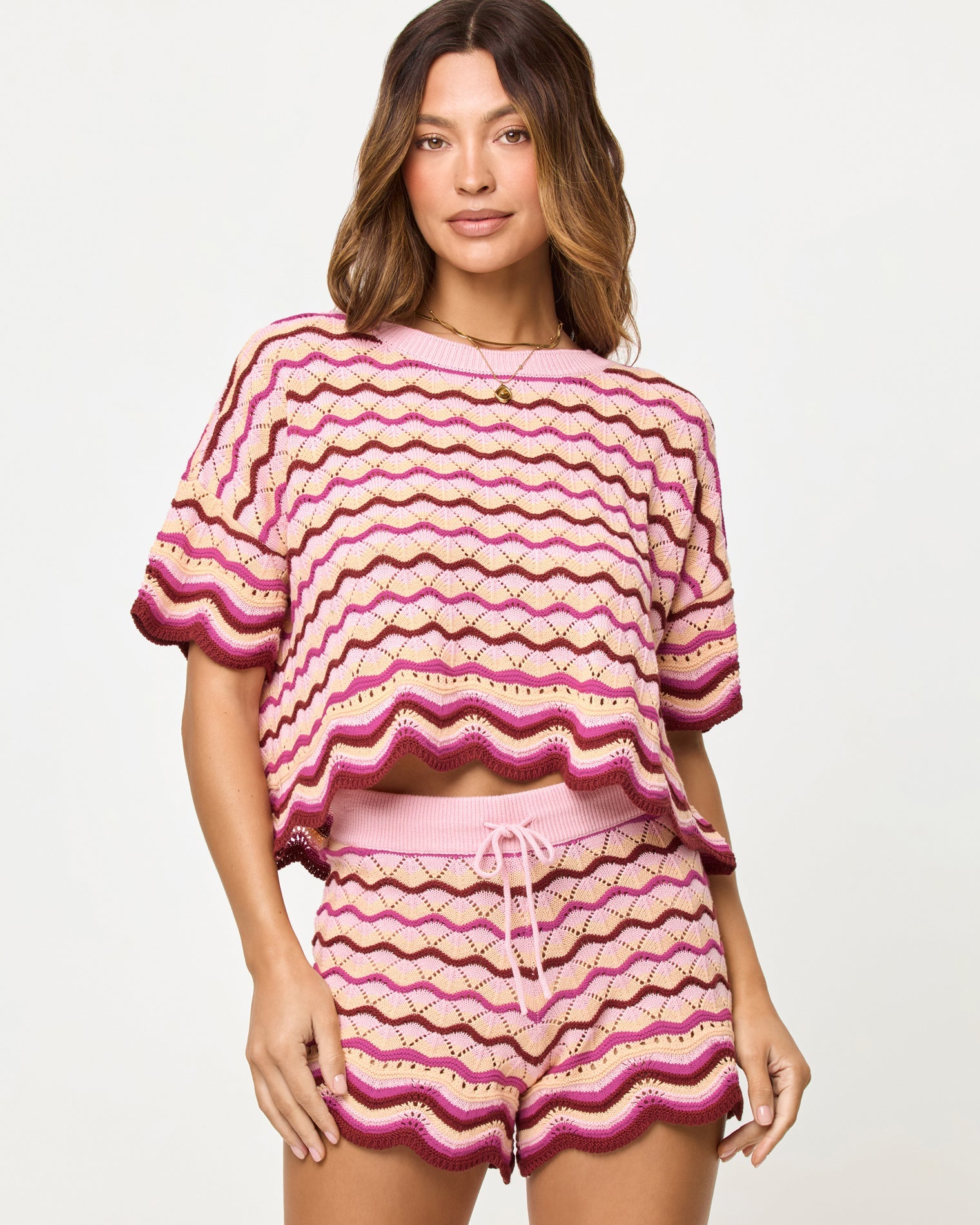 Berry Spritz | Badge:New Arrival_#B2AC88_#ffffff'
Close-up front view of model wearing the LSPACE Sunchaser Top and Short in berry spritz showing the wave crochet pattern and scalloped hem detail.