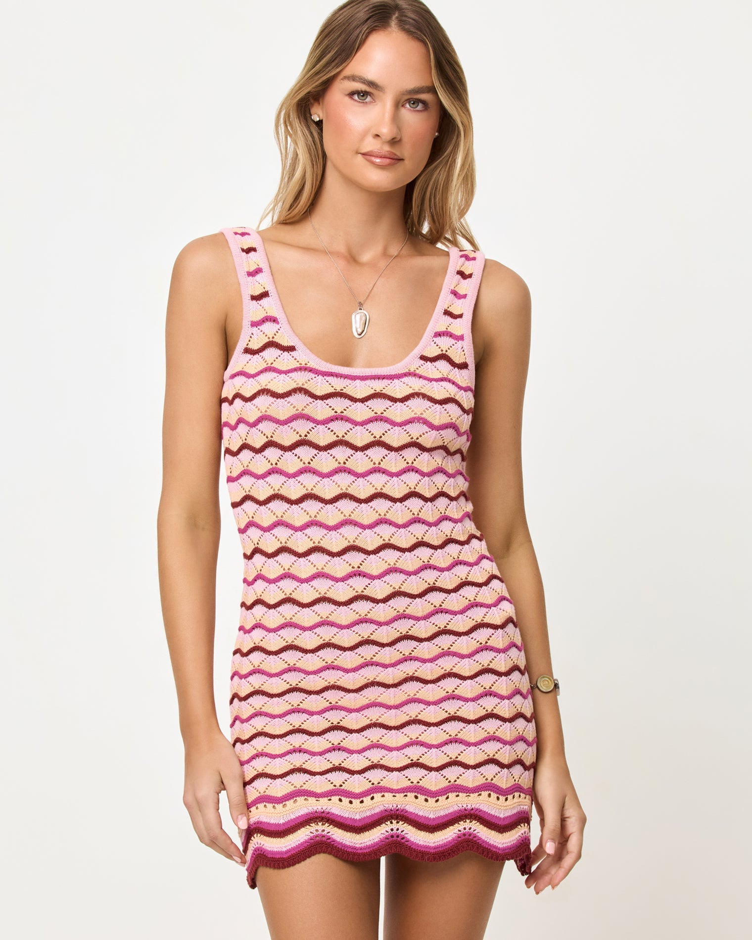 Close-up front view of model wearing the LSPACE Sunchaser Dress in berry spritz showing the wave crochet pattern and scoop neckline.