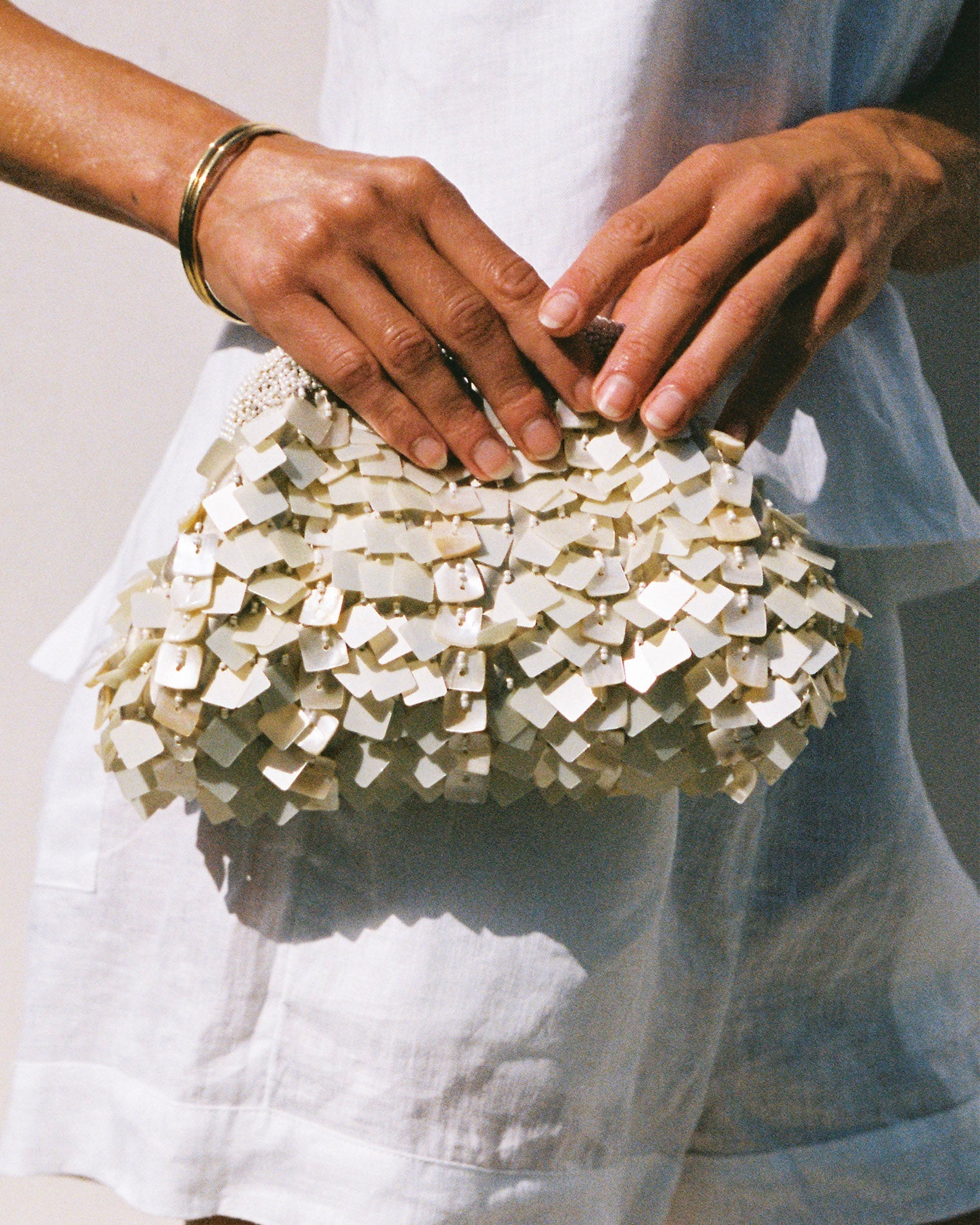 Cream | Badge:New Arrival_#B2AC88_#ffffff' Cream clutch bag with sequins and shells