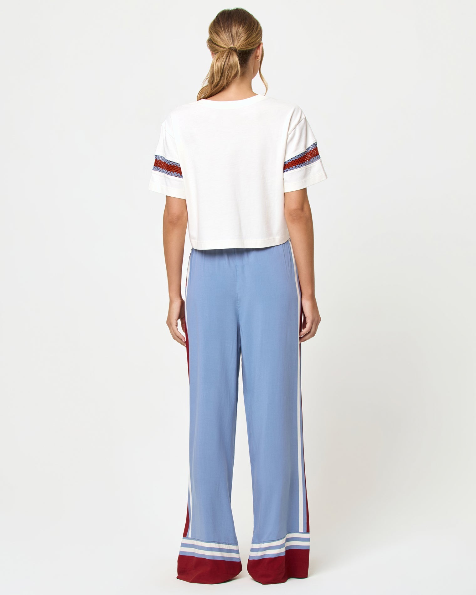 Back view of model wearing the LSPACE Unwind Pant in unwind stripe.